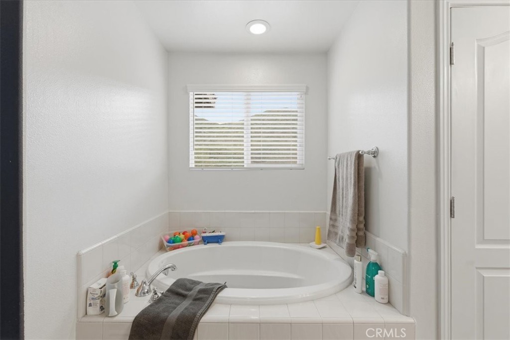 34326 Heather Ridge Road Lake Elsinore, CA 92532 - Photo 34 of 46 a bath tub sitting in a bathroom next to a window