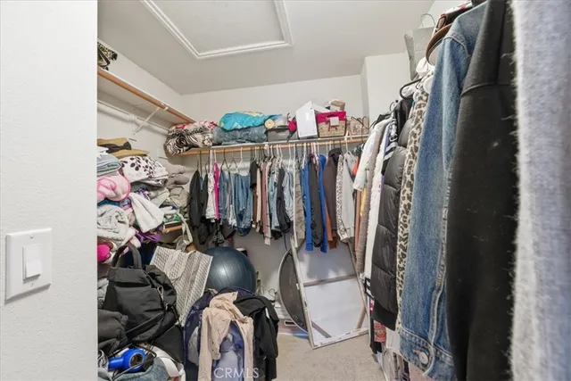 a view of walk in closet with clothes