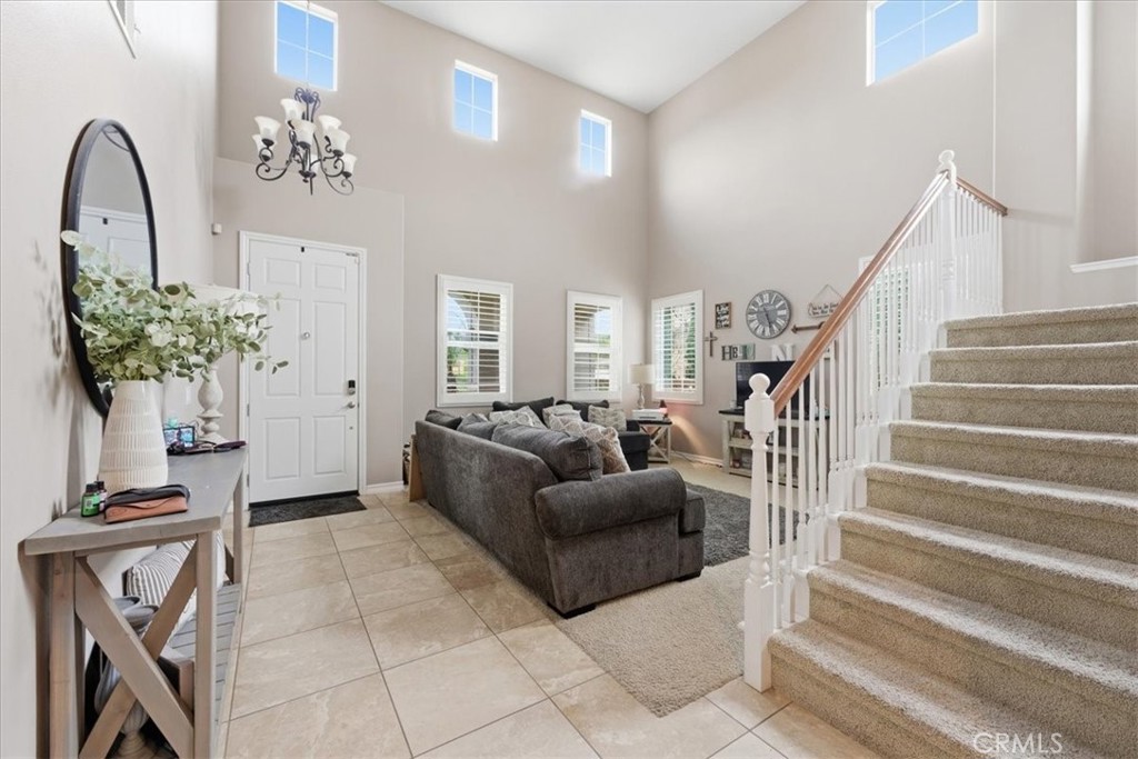34326 Heather Ridge Road Lake Elsinore, CA 92532 - Photo 4 of 46 a living room with furniture and a chandelier