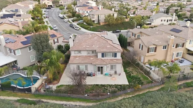 an aerial view of residential houses with outdoor space and swimming pool