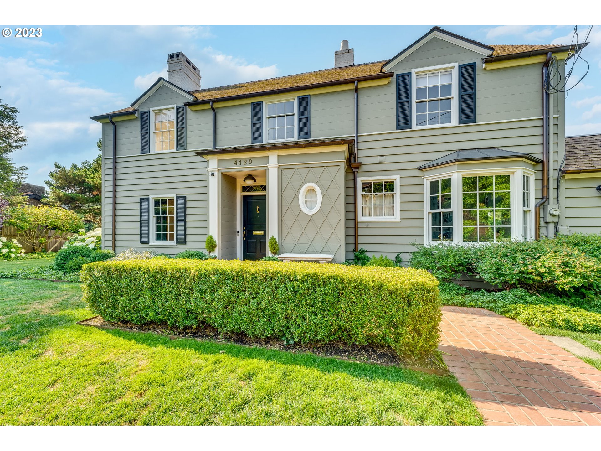 a front view of a house with a garden