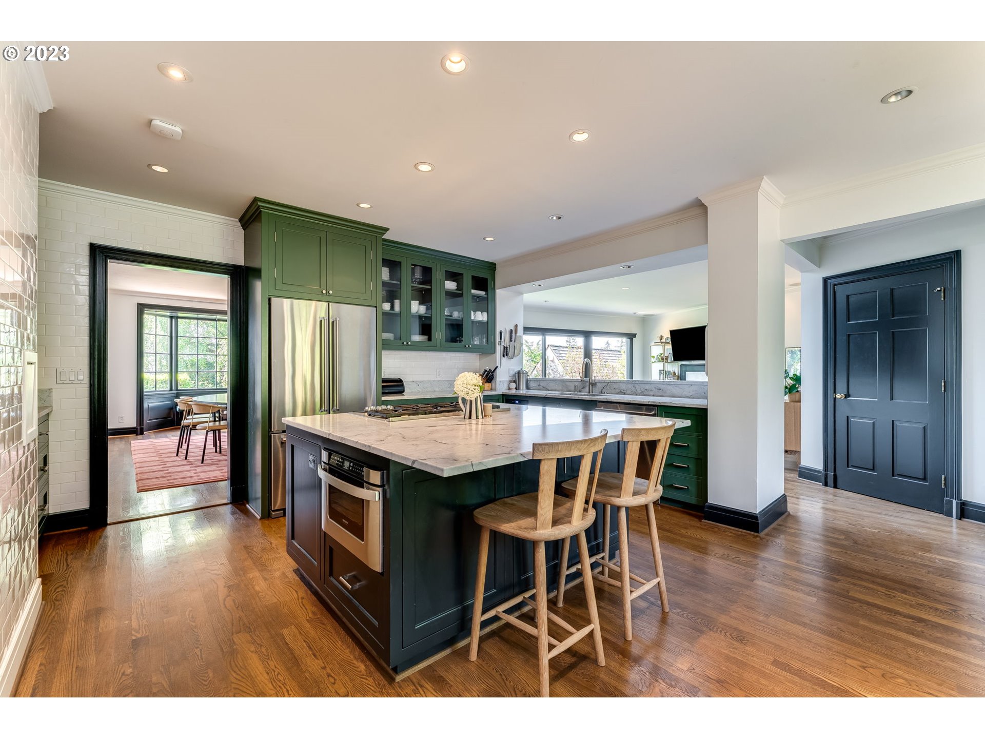 4129 Southwest Greenleaf Court Portland, OR 97221 - Photo 13 of 48 a kitchen with stainless steel appliances granite countertop a kitchen island a stove a table and chairs