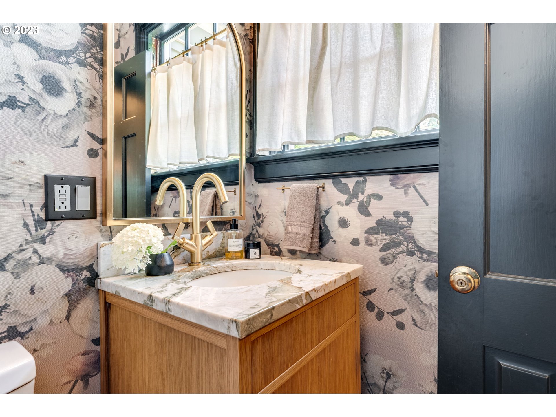 4129 Southwest Greenleaf Court Portland, OR 97221 - Photo 19 of 48 a bathroom with a sink vanity and a mirror