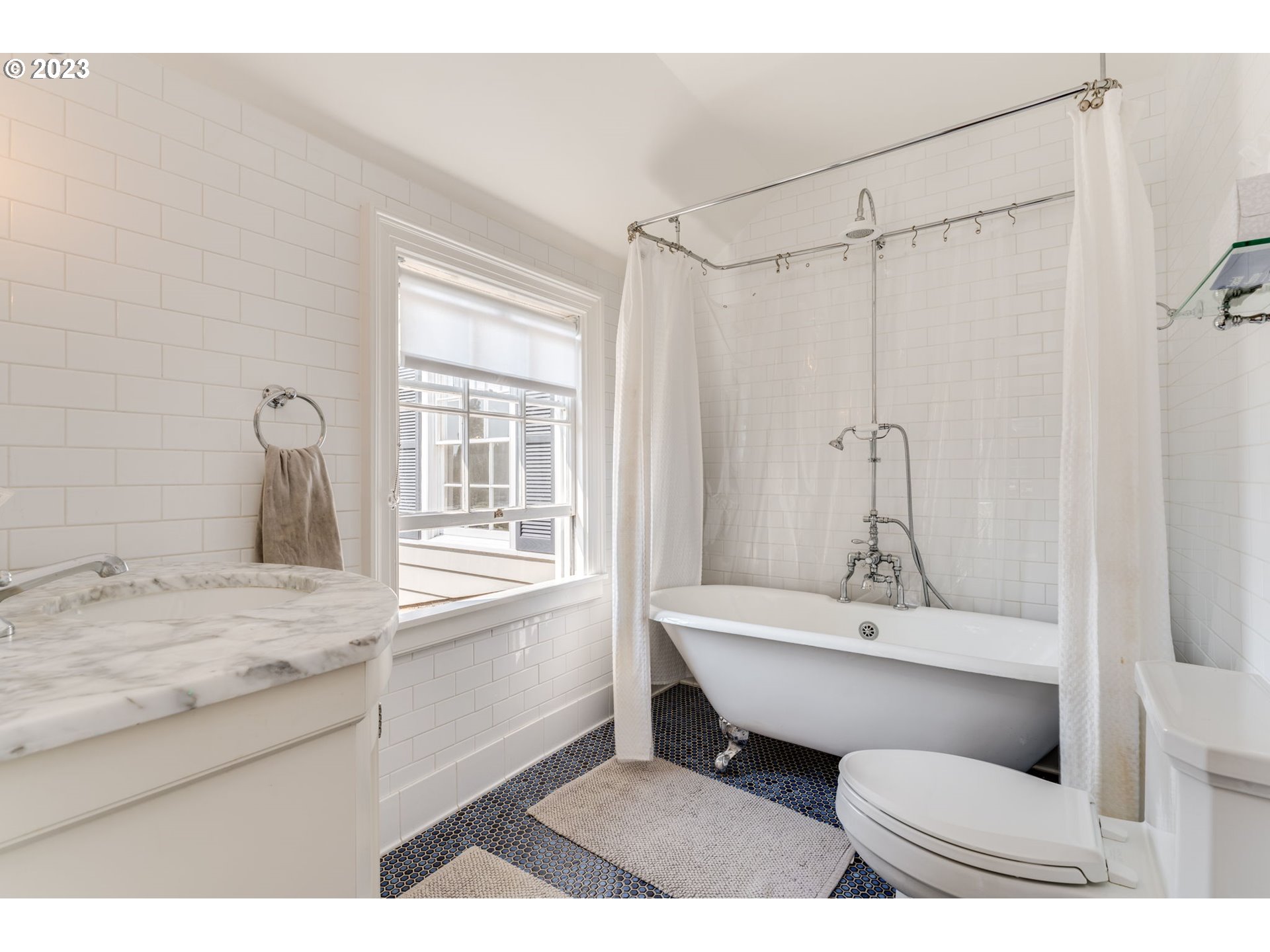 4129 Southwest Greenleaf Court Portland, OR 97221 - Photo 26 of 48 a bathroom with a sink toilet a mirror and bathtub