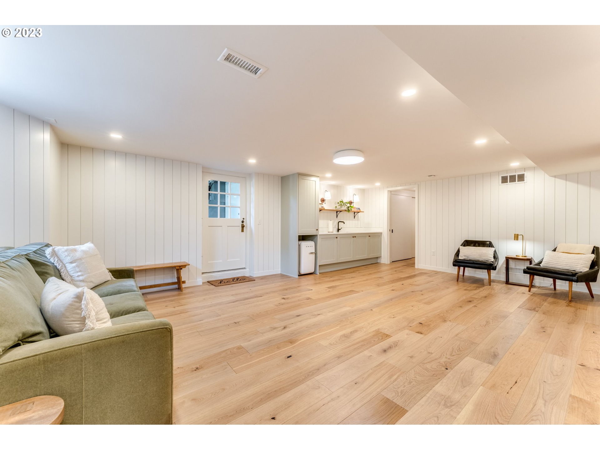 4129 Southwest Greenleaf Court Portland, OR 97221 - Photo 31 of 48 a living room with furniture and a dining table with kitchen view