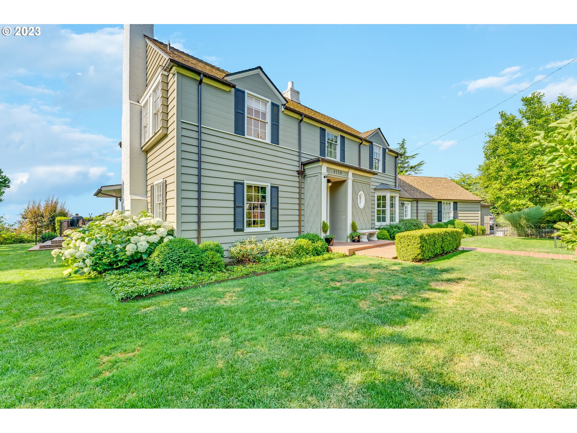 4129 Southwest Greenleaf Court Portland, OR 97221 - Photo 37 of 48 a front view of a house with a yard