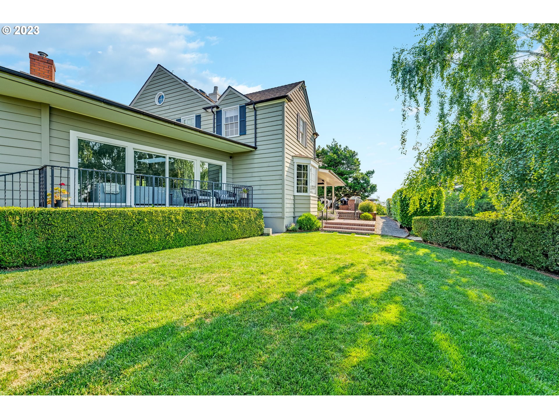4129 Southwest Greenleaf Court Portland, OR 97221 - Photo 38 of 48 a front view of a house with a yard