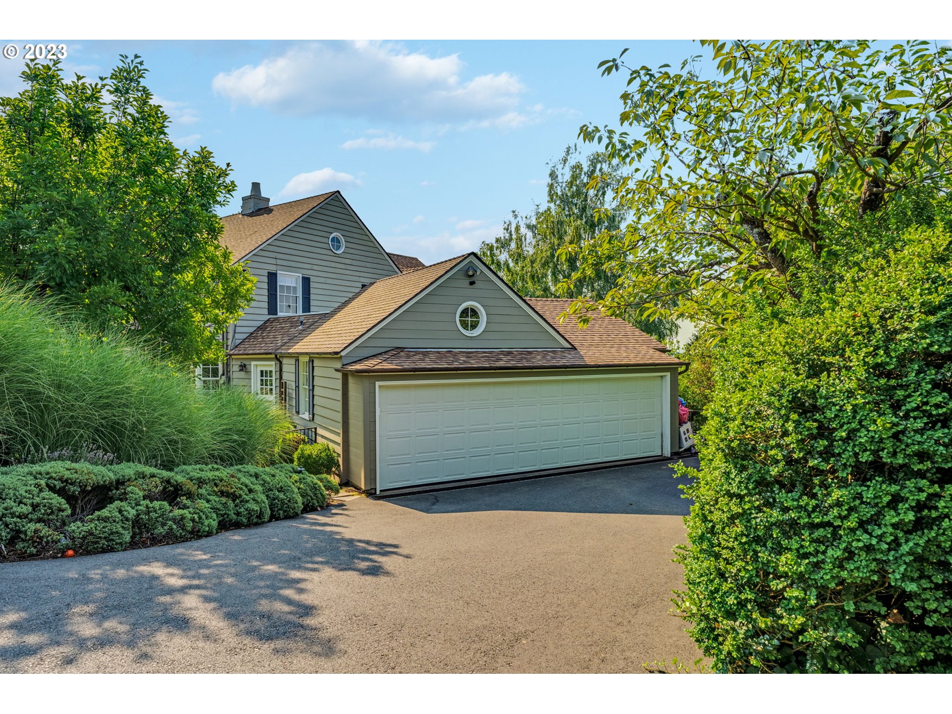 4129 Southwest Greenleaf Court Portland, OR 97221 - Photo 41 of 48 a front view of a house with a garden