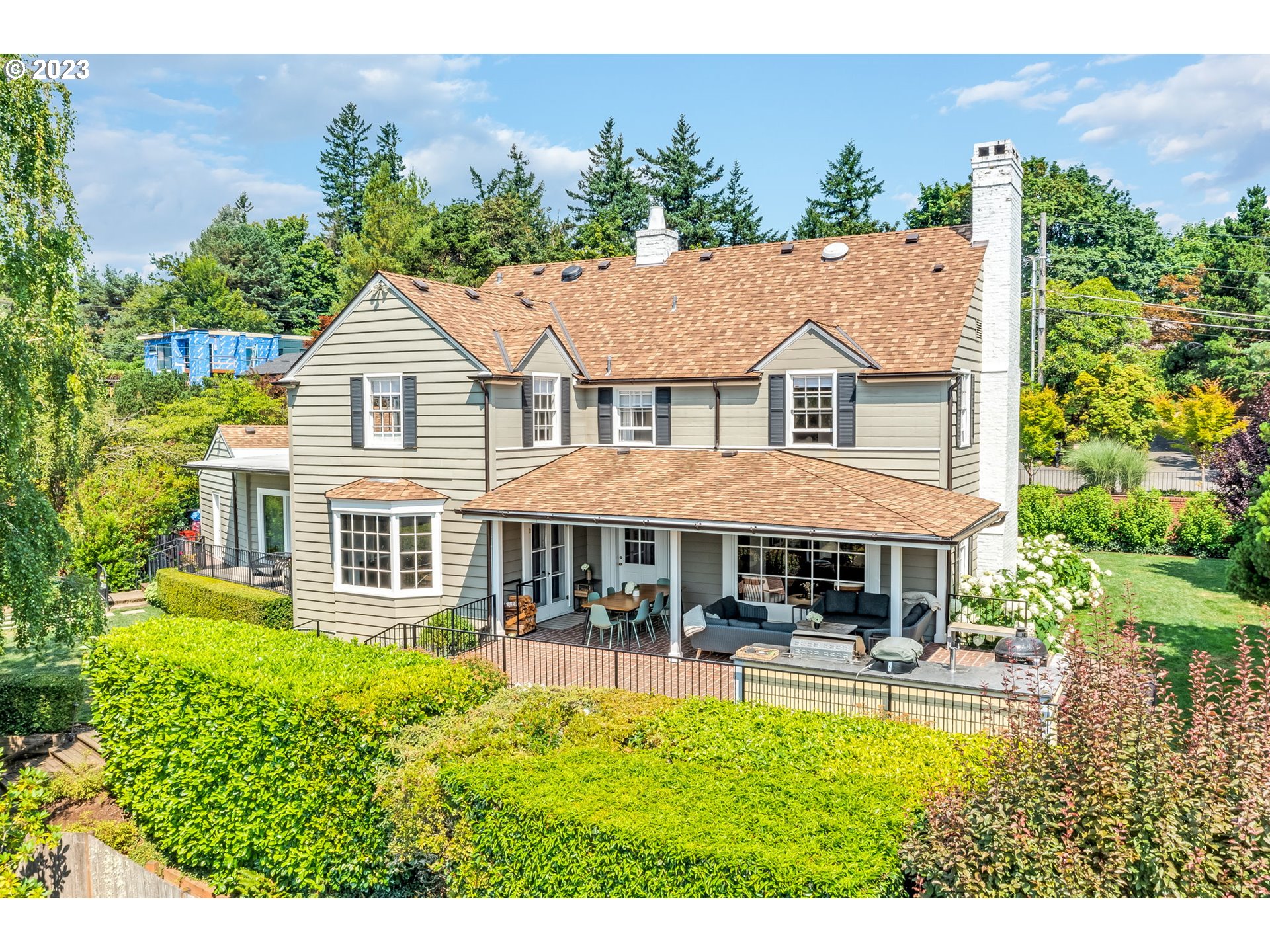 4129 Southwest Greenleaf Court Portland, OR 97221 - Photo 43 of 48 a view of a house with a yard and potted plants