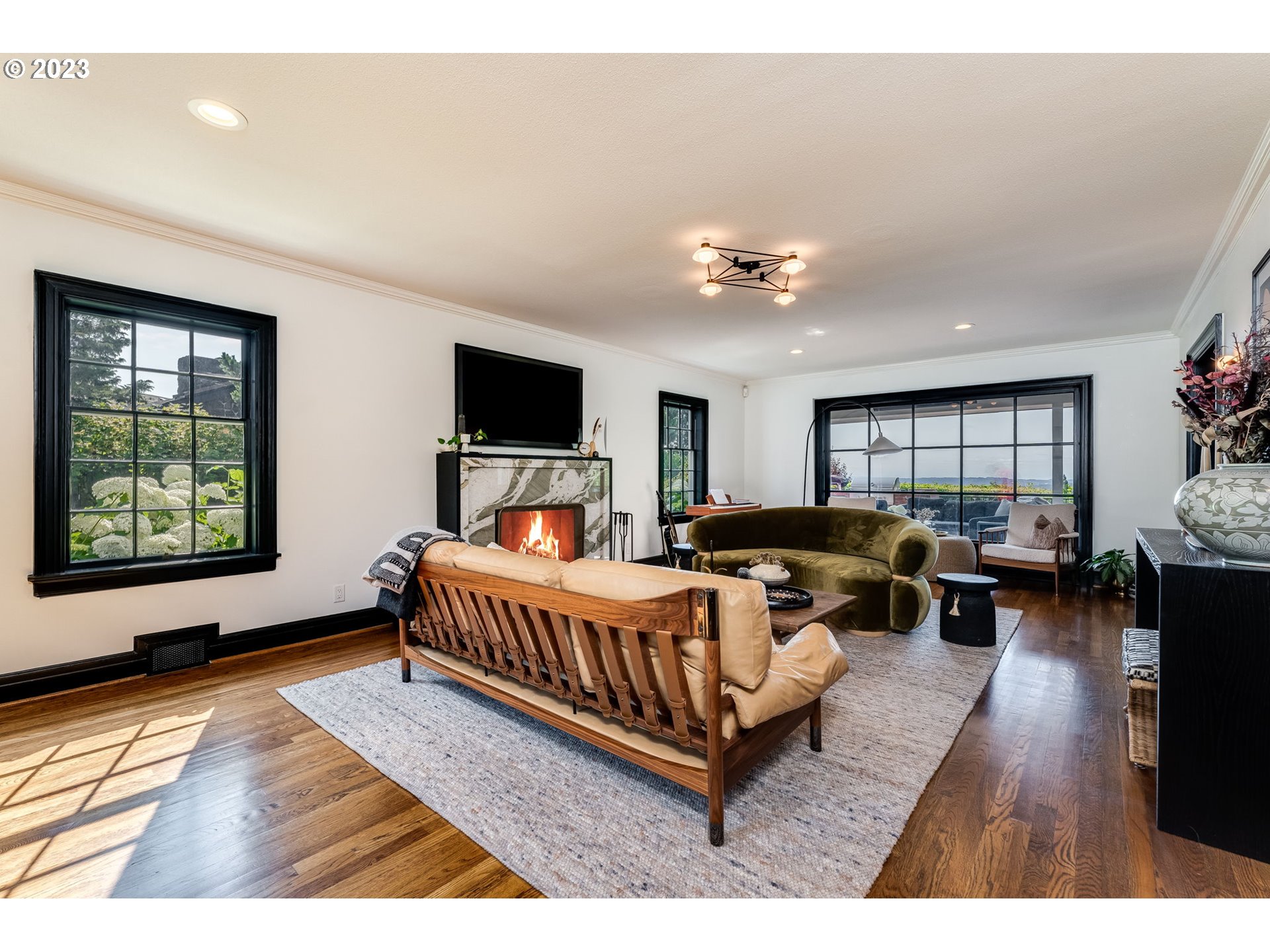 4129 Southwest Greenleaf Court Portland, OR 97221 - Photo 5 of 48 a spacious bedroom with a bed couch and window