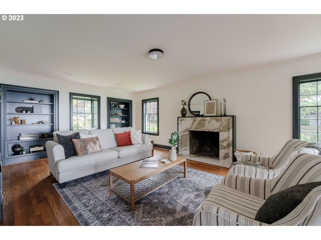 4129 Southwest Greenleaf Court Portland, OR 97221 - Photo 7 of 48 a living room with furniture a fireplace and a window