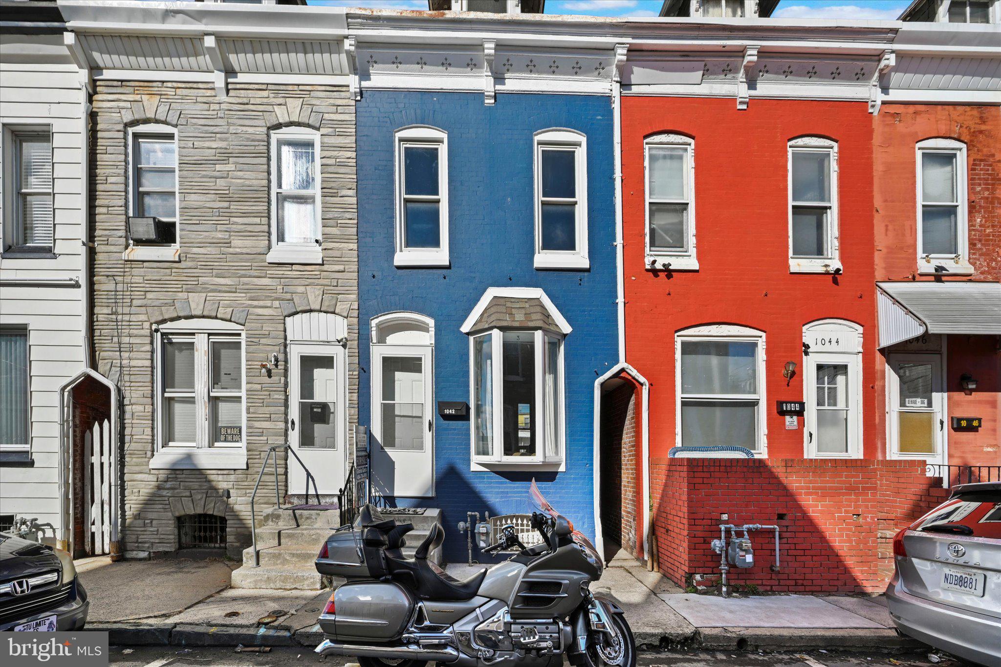 1042 Locust Street Reading, PA 19604 - Photo 1 of 28 a front view of a house with many windows