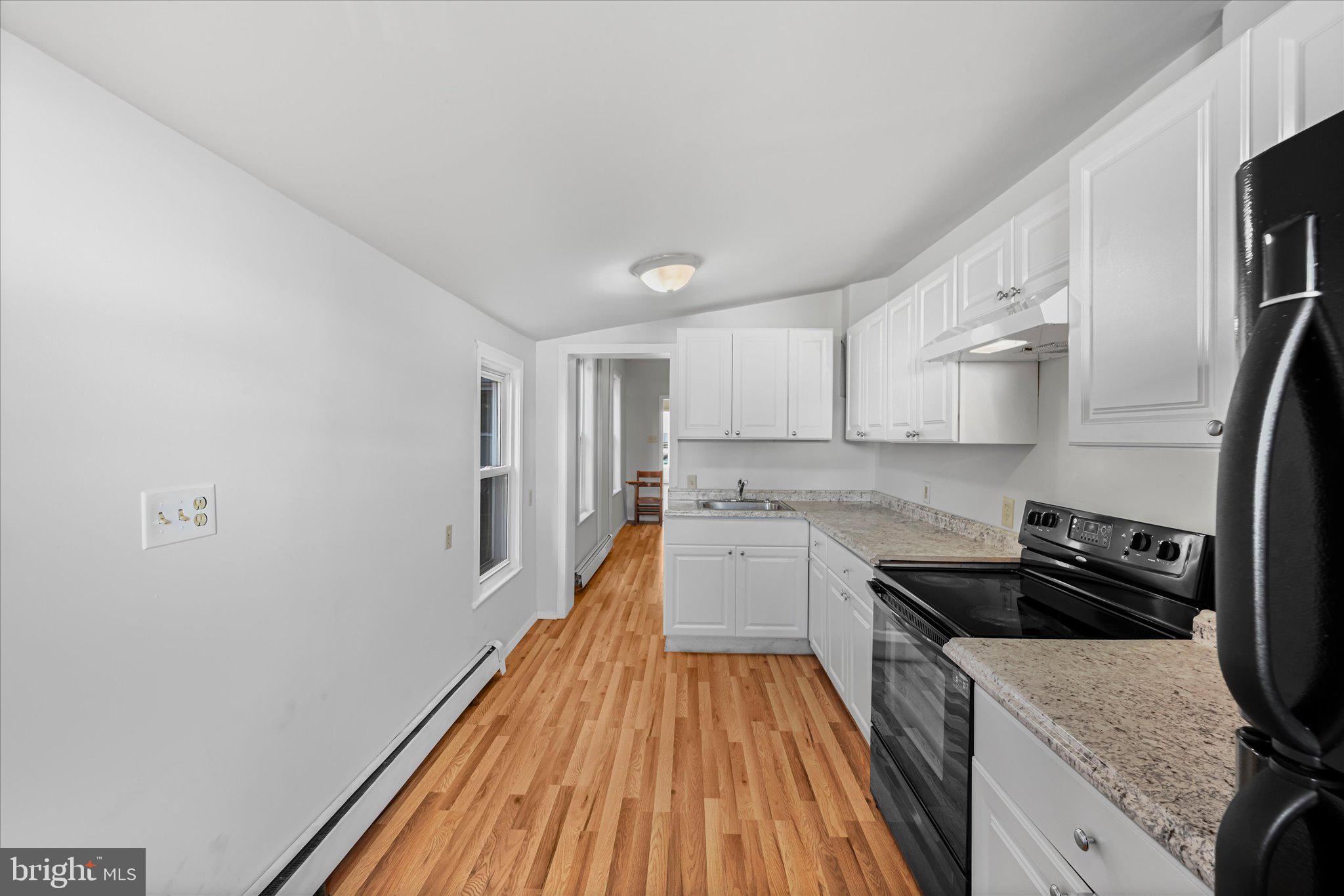 1042 Locust Street Reading, PA 19604 - Photo 11 of 28 a kitchen with a sink and wooden floor