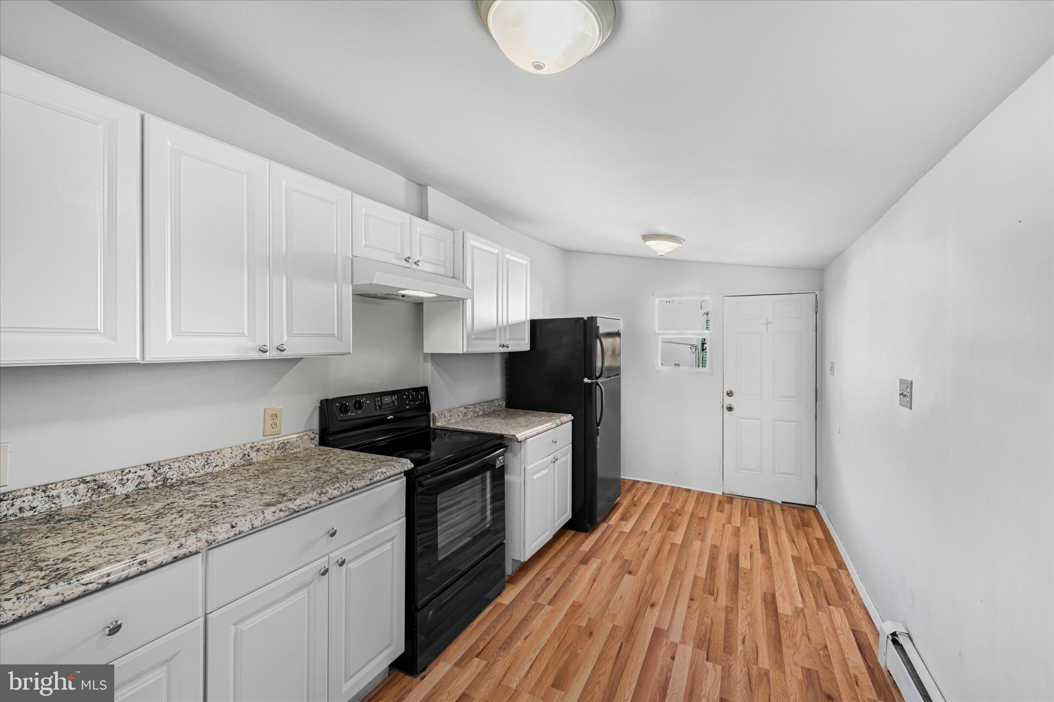 1042 Locust Street Reading, PA 19604 - Photo 12 of 28 a kitchen with granite countertop a sink cabinets stainless steel appliances and a counter space
