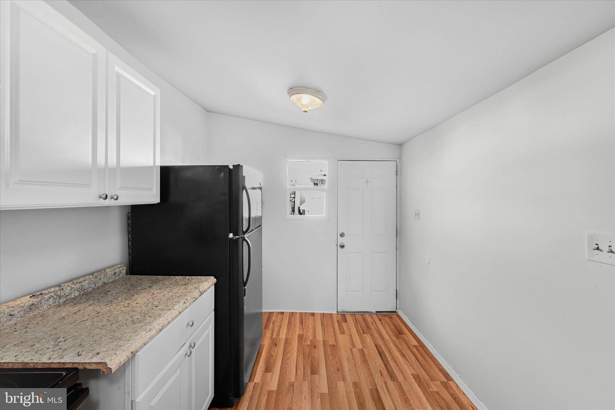 1042 Locust Street Reading, PA 19604 - Photo 14 of 28 a kitchen with a refrigerator and cabinets