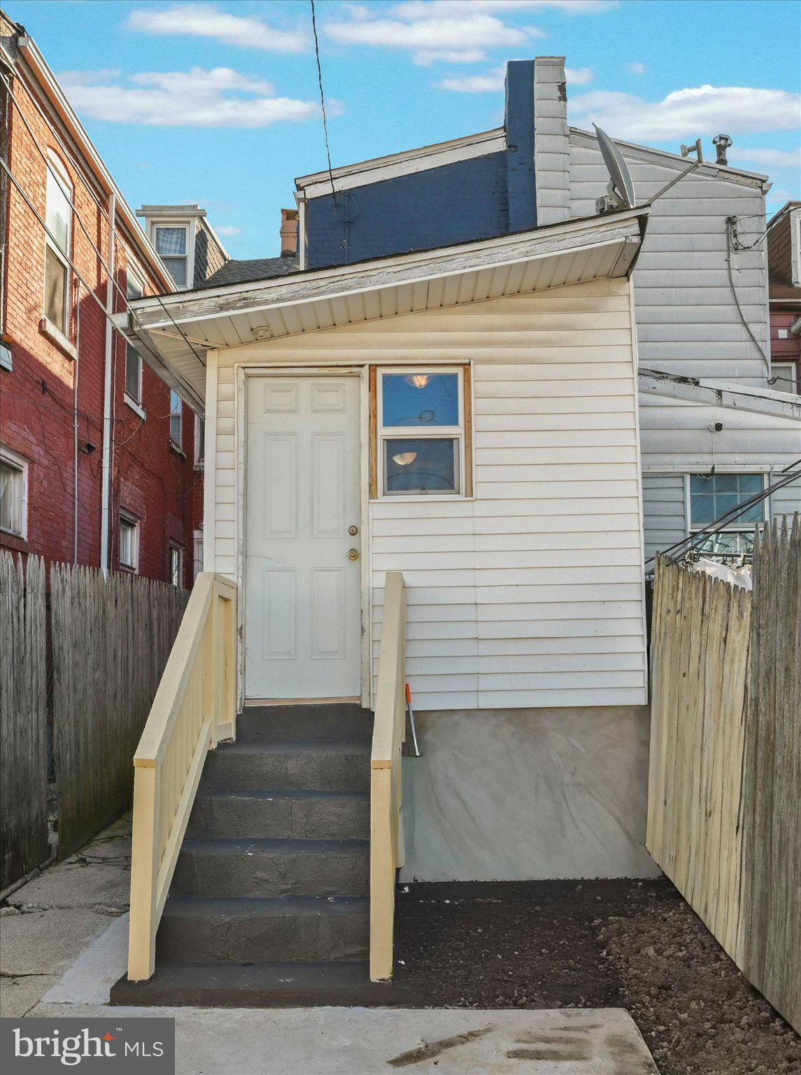 1042 Locust Street Reading, PA 19604 - Photo 24 of 28 a view of a house with stairs and wooden door