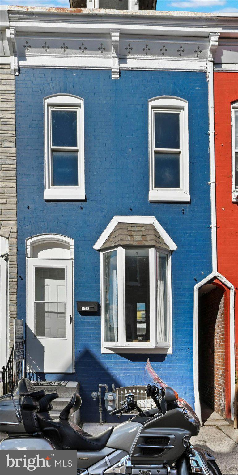 1042 Locust Street Reading, PA 19604 - Photo 3 of 28 a front view of a house with many windows