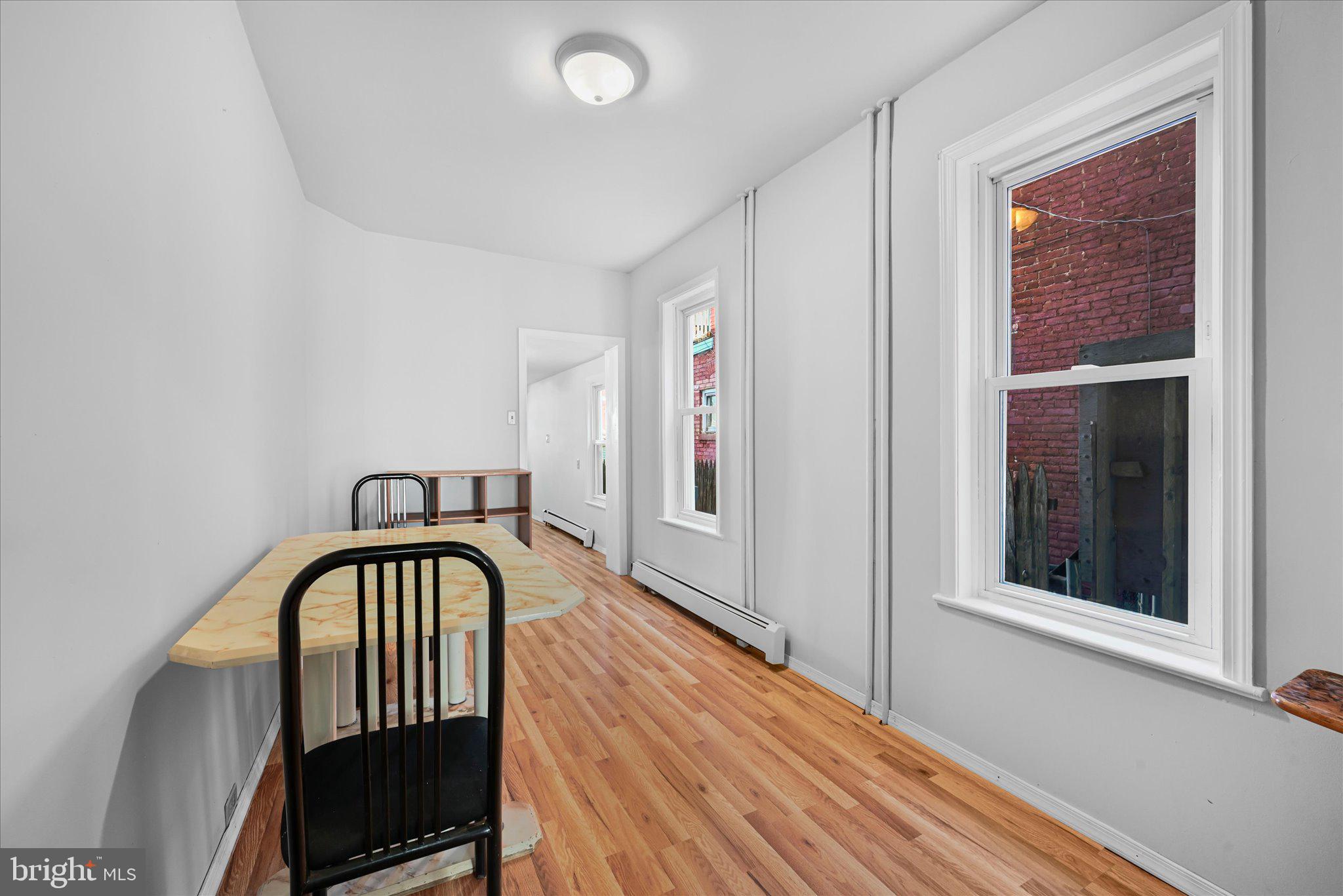 1042 Locust Street Reading, PA 19604 - Photo 8 of 28 a view of a hallway with wooden floor and staircase