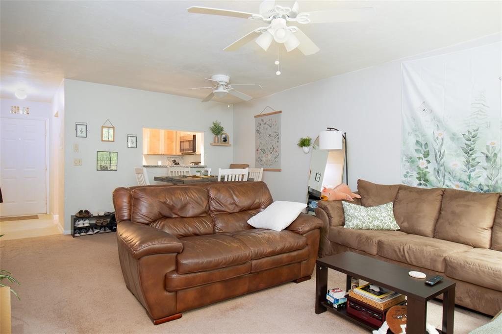 2300 Southwest 43rd Street, Unit K5 Gainesville, FL 32607 - Photo 7 of 18 a living room with furniture a couch and chandelier