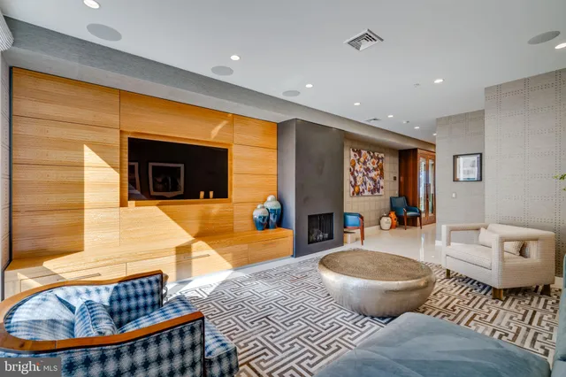 a living room with furniture a rug and a fireplace