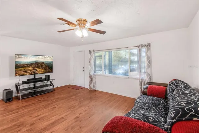 a living room with furniture and a chandelier