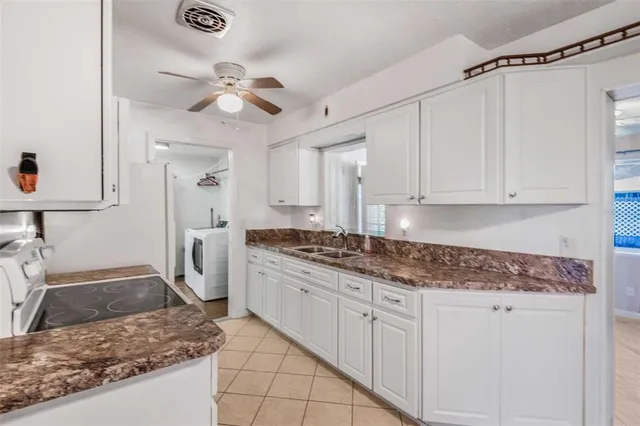 a view of a kitchen with wooden floor and cabinets