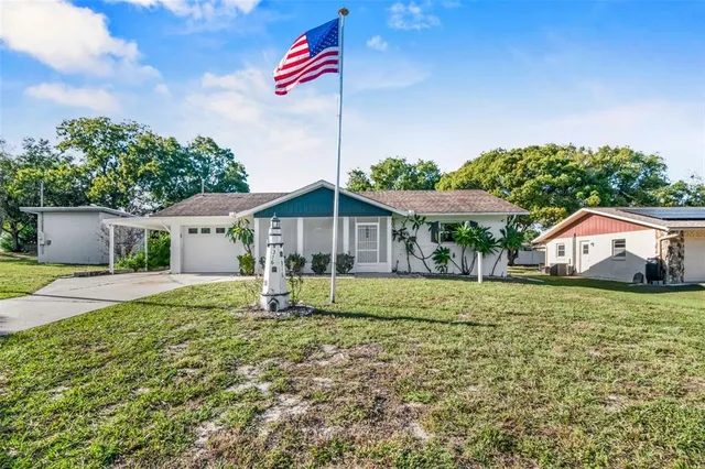 a house with green field in front of it