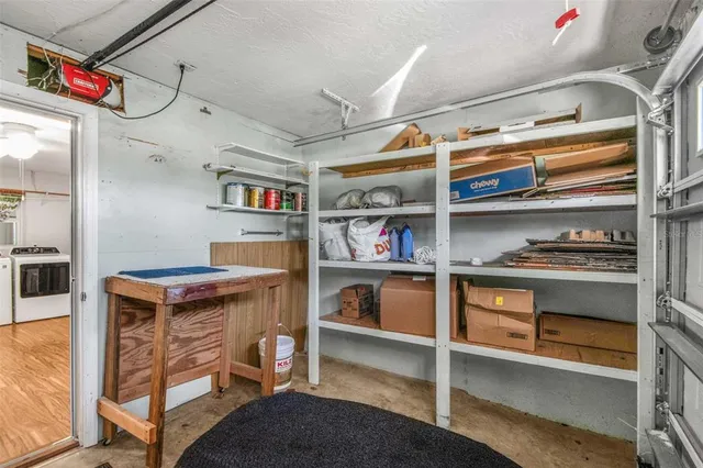 a kitchen with a refrigerator and ceiling fan