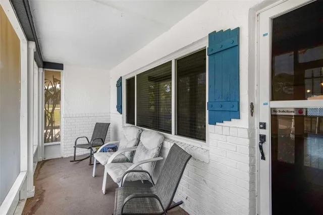 a view of a porch with furniture and next to a window