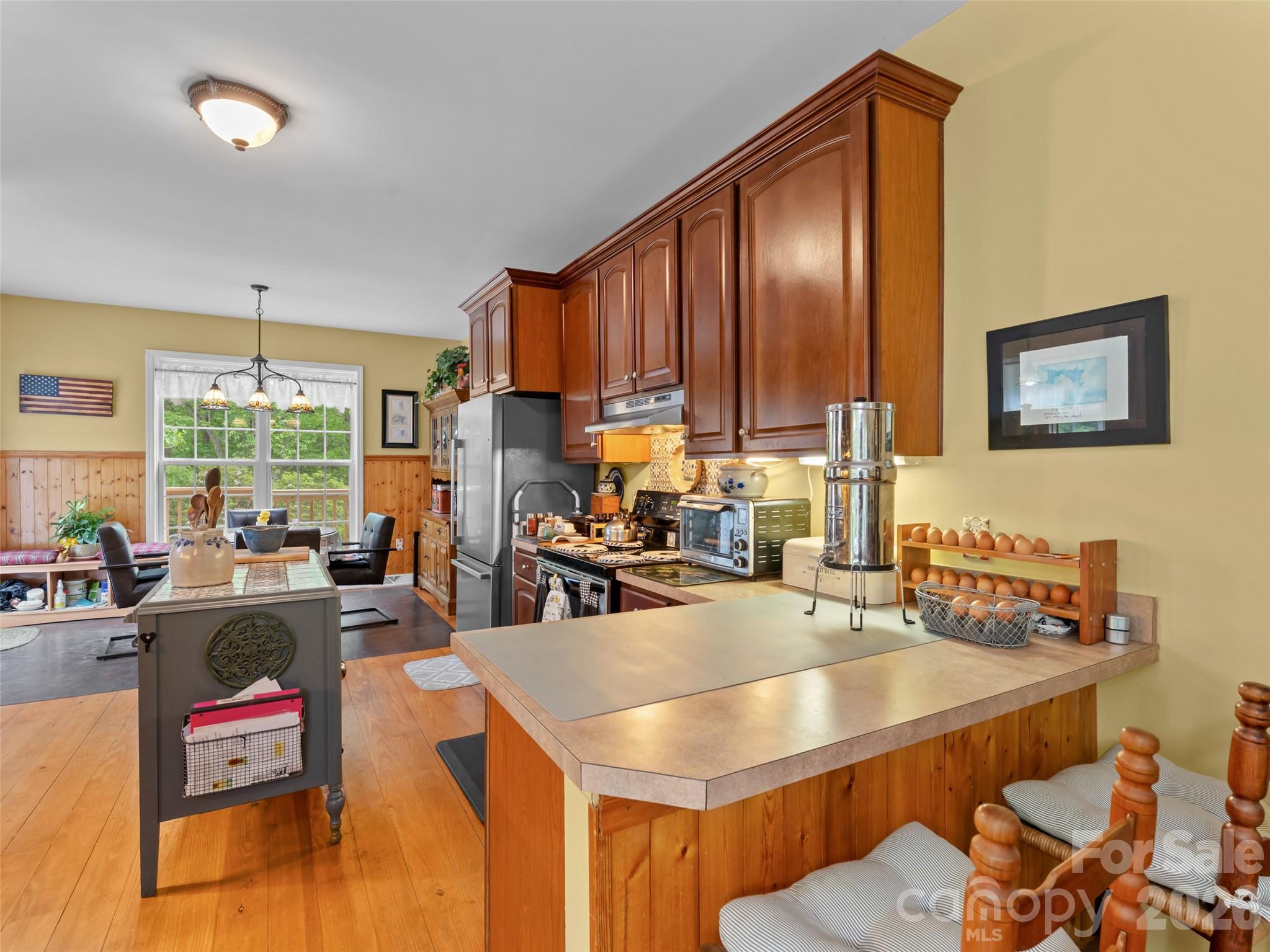 103 Old Southside Road Saluda, NC 28773 - Photo 16 of 48 a kitchen with kitchen island granite countertop a sink stove and cabinets