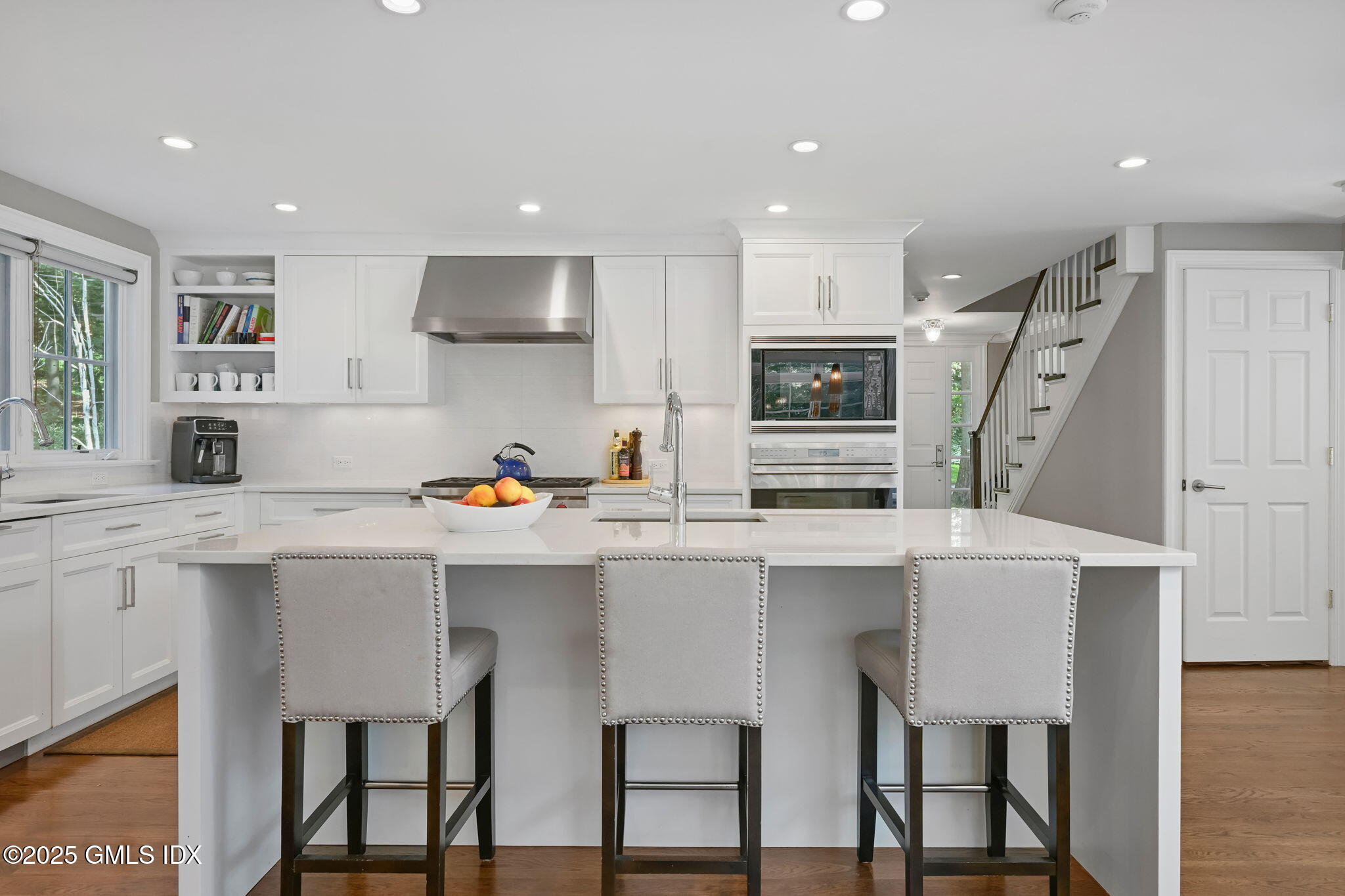 37 Ridgeview Avenue Greenwich, CT 06830 - Photo 27 of 49 a kitchen with stainless steel appliances a white table chairs refrigerator and sink