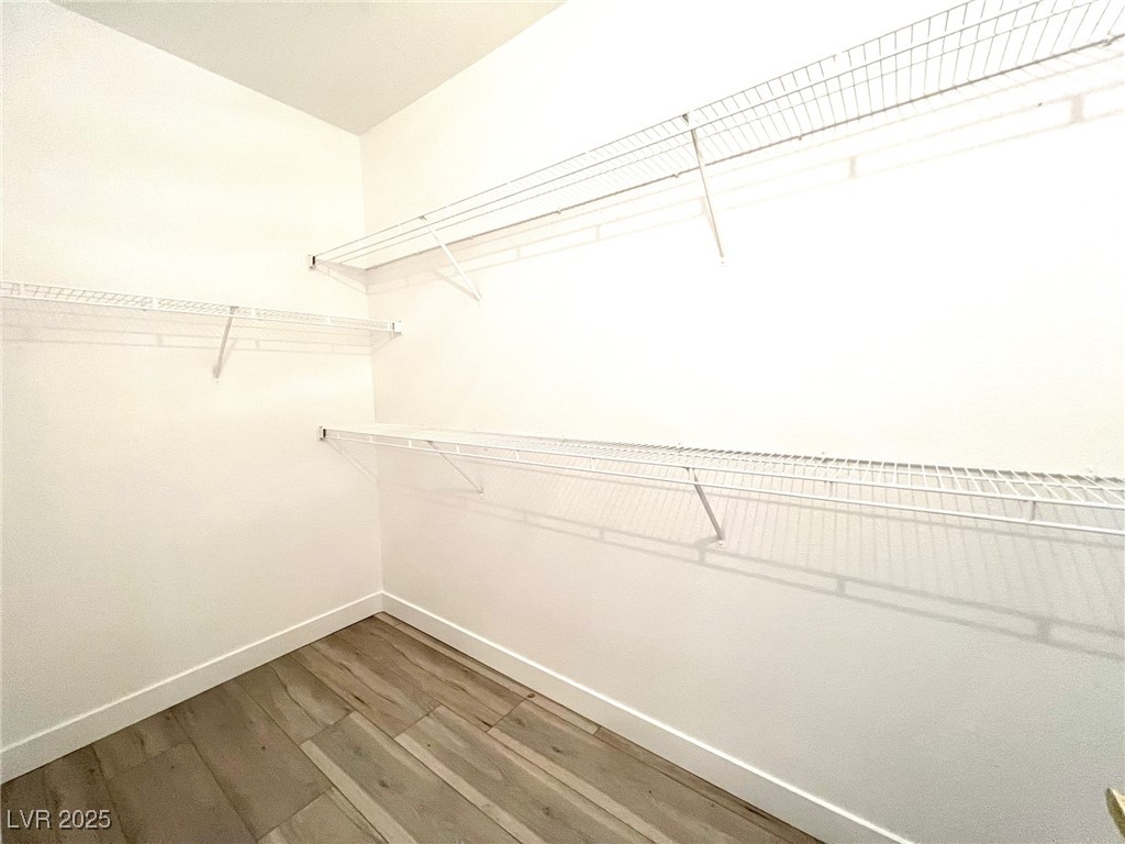 7135 South Durango Drive, Unit 304 Las Vegas, NV 89113 - Photo 4 of 11 Walk in closet featuring wood finished floors
