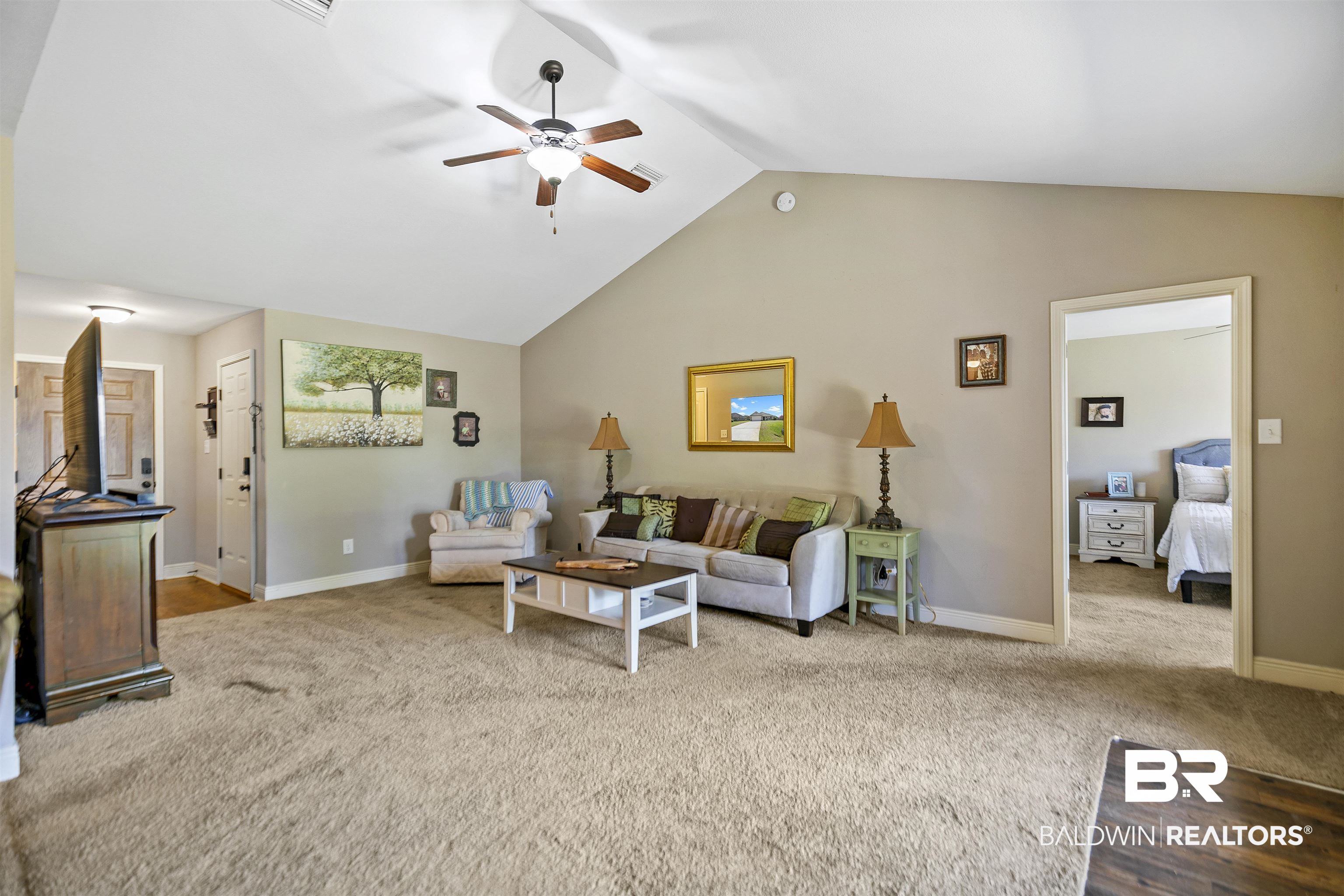 18738 Explorer Drive Loxley, AL 36551 - Photo 9 of 38 Carpeted living room featuring ceiling fan and vaulted ceiling