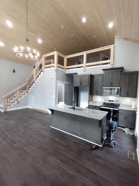 a view of kitchen with kitchen island microwave and wooden floor