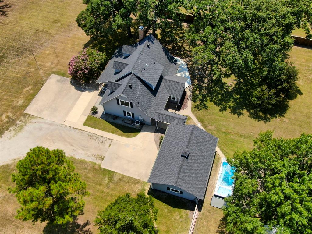 an aerial view of a house with a yard