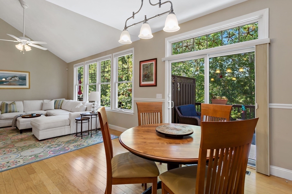 23 Sea Spray Avenue, Unit 563 Mashpee, MA 02649 - Photo 16 of 39 a view of a dining room with furniture a chandelier and wooden floor