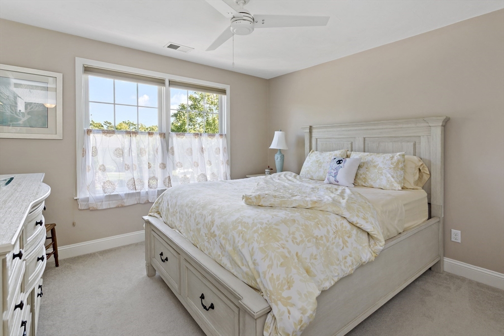 23 Sea Spray Avenue, Unit 563 Mashpee, MA 02649 - Photo 26 of 39 a bedroom with a bed and a window