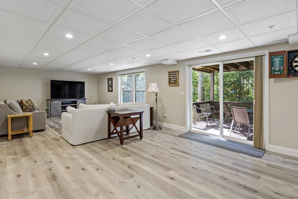 23 Sea Spray Avenue, Unit 563 Mashpee, MA 02649 - Photo 29 of 39 a living room with furniture and a flat screen tv