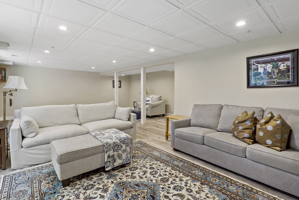 23 Sea Spray Avenue, Unit 563 Mashpee, MA 02649 - Photo 31 of 39 a living room with furniture and a couch