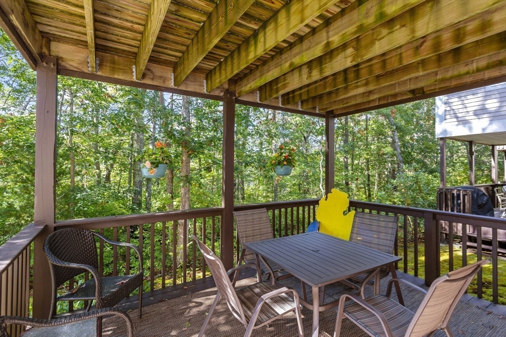 23 Sea Spray Avenue, Unit 563 Mashpee, MA 02649 - Photo 34 of 39 a view of a chair and table in the balcony