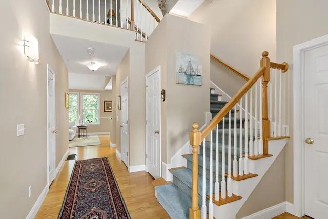 a view of a hallway with wooden floor and staircase