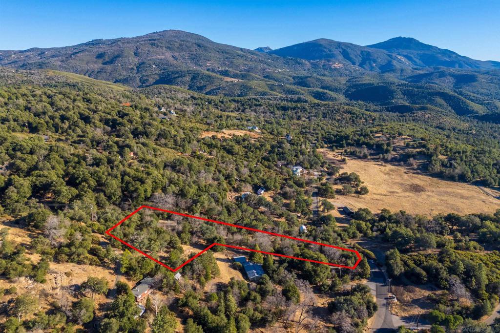 5298 Pine Hills Road Julian, CA 92036 - Photo 17 of 21 a view of a lush green hillside and a building