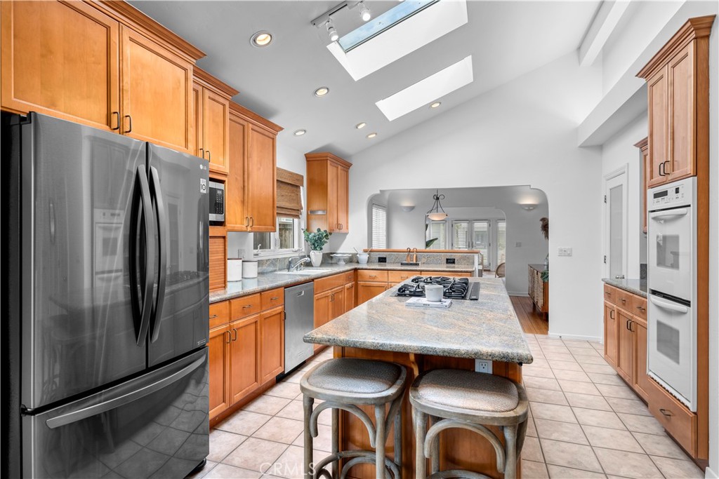 412 5th Street Manhattan Beach, CA 90266 - Photo 18 of 44 a kitchen with a table chairs refrigerator and microwave
