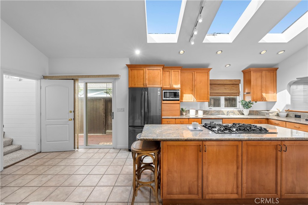 412 5th Street Manhattan Beach, CA 90266 - Photo 21 of 44 a kitchen with stainless steel appliances granite countertop a stove a sink and a refrigerator