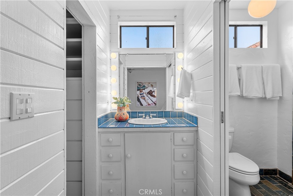 412 5th Street Manhattan Beach, CA 90266 - Photo 27 of 44 a bathroom with a sink a toilet and a mirror