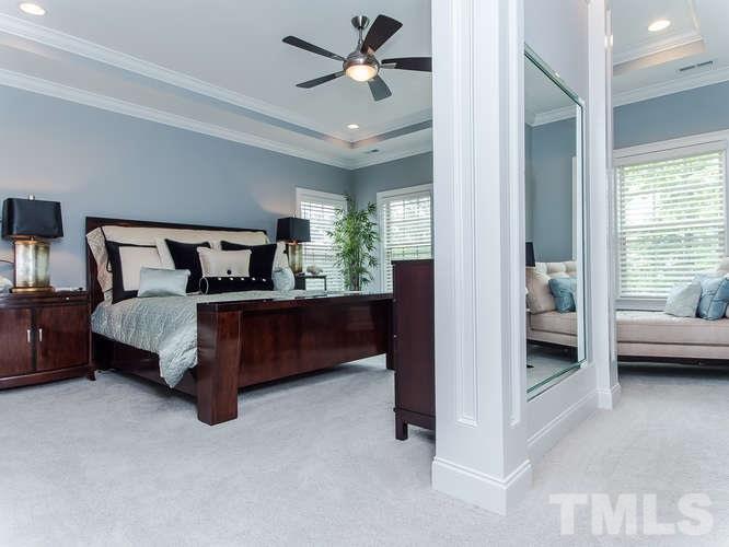 3619 Rolston Drive Raleigh, NC 27609 - Photo 11 of 24 Elegant Owner's Suite with trey ceiling with recessed lights, a sitting area, an amazing wall with mirror on one side and TV on other side adds privacy and beauty to a special place.