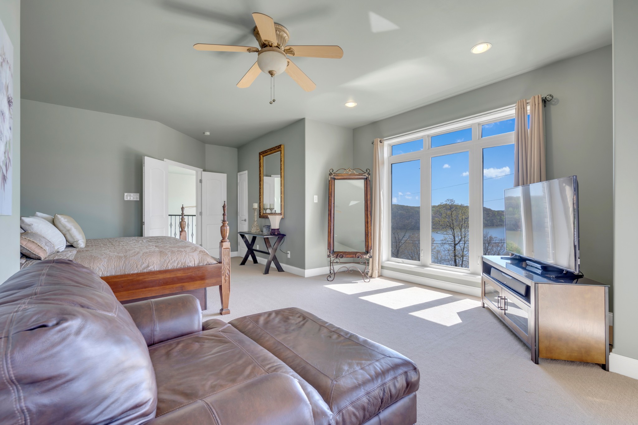 501 River Trace Road Dover, TN 37058 - Photo 45 of 84 a spacious bedroom with a large bed and a chandelier