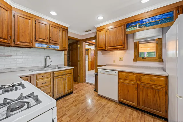 a kitchen with stainless steel appliances a refrigerator and a stove top oven