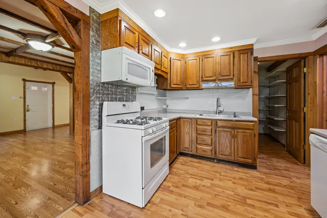 a view of empty room with wooden floor and windows