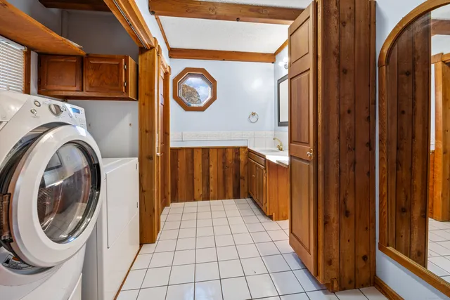 a bathroom with a toilet a sink and mirror